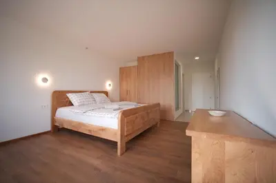 a bedroom with a bed and a wooden cabinet at Motel Vujeva in Livno