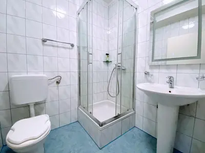 a bathroom with a shower and a toilet and a sink at Motel Vujeva in Livno