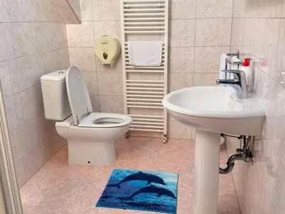 a bathroom with a toilet and a sink at Gradska Kavana Guest House in Kupres