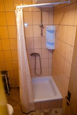 a bathroom with a shower with a bath tub at Guesthouse Nevenko in Kupres