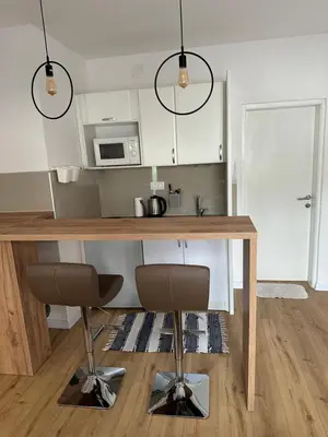 a kitchen with a wooden table and two chairs at Una La Unica in Bihać