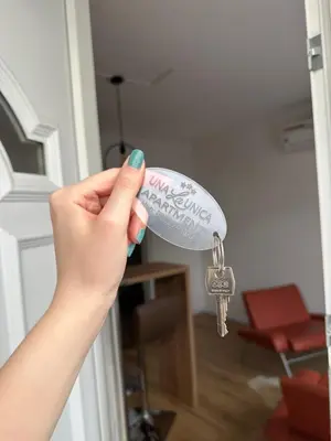 a person holding a bunch of keys on a door at Una La Unica in Bihać