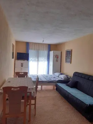 a living room with a couch and a bed and a table at Apartman Aurelia in Bihać