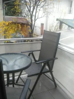 a chair and a table on a balcony at Apartman Aurelia in Bihać