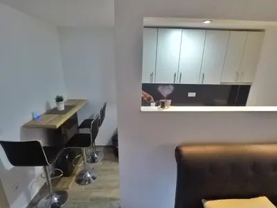 a kitchen with a table and chairs in a room at Studio apartman Centar in Banja Luka