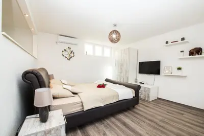 a bedroom with a bed and a television in it at Studio apartman Centar in Banja Luka