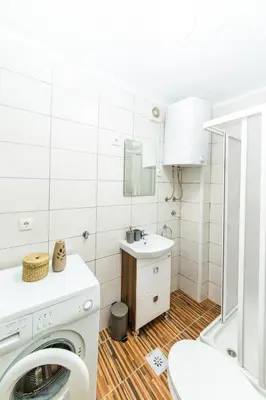 a bathroom with a washing machine and a sink at Apartman Centar in Banja Luka