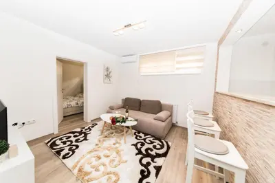 a living room with a couch and a table at Apartman Top Spot in Banja Luka