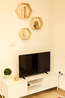 a flat screen tv sitting on top of a white entertainment center at Apartman Top Spot in Banja Luka