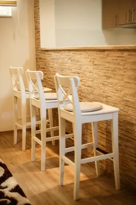 a white table and four white chairs in a kitchen at Apartman Top Spot in Banja Luka