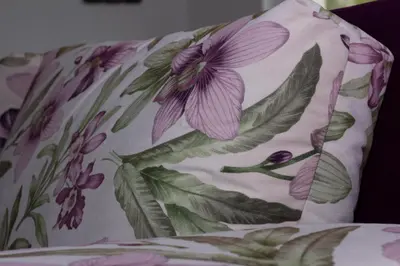 a pillow with a purple flower pattern on it at Apartman Marija in Banja Luka