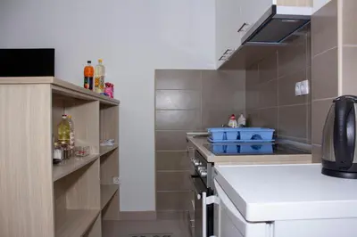 a small kitchen with a sink and a stove at Apartman Marija in Banja Luka