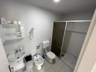 a bathroom with a toilet and a sink and a shower at Hotel River View bihac in Lohovo