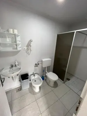 a bathroom with a toilet and a sink and a shower at Hotel River View bihac in Lohovo