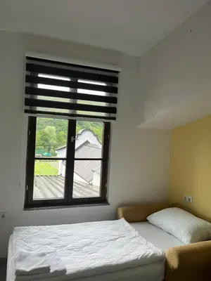 a bedroom with a bed and a window at Hotel River View bihac in Lohovo