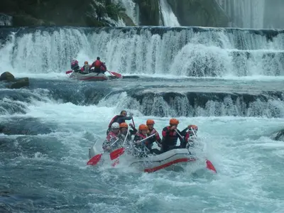 a group of people on a raft in a waterfall at Hotel River View bihac in Lohovo