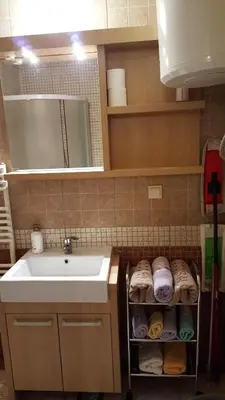 a bathroom with a sink and a mirror and a towel rack at MIMI 302 Eko Fis Vlasic in Vlasic