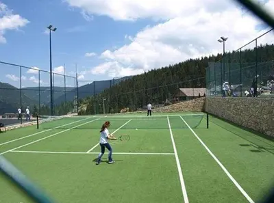 a young girl playing tennis on a tennis court at MIMI 302 Eko Fis Vlasic in Vlasic