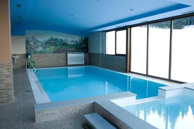 a large swimming pool with blue water and windows at MIMI 302 Eko Fis Vlasic in Vlasic