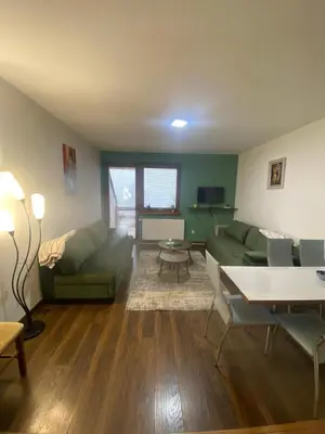 a living room with a green couch and a table at MIMI 302 Eko Fis Vlasic in Vlasic