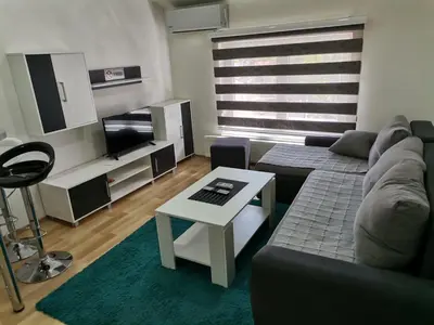 a living room with a couch and a table at Centar Apartman ENMI 111 in Banja Luka