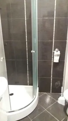 a bathroom with a toilet and a glass shower at Centar Apartman ENMI 111 in Banja Luka