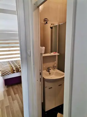a bathroom with a sink and a mirror at Centar Apartman ENMI 111 in Banja Luka