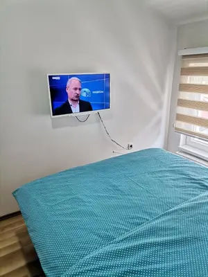 a tv hanging on a wall in a room at Centar Apartman ENMI 111 in Banja Luka