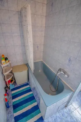 a blue bath tub with a faucet in a bathroom at Apartman Penthaus u strogom centru Banja Luke in Banja Luka