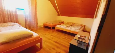 a small room with two beds and a table at Vinara Kupres in Kupres