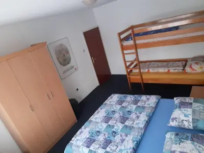 a bedroom with two beds and a bunk bed at Vinara Kupres in Kupres