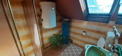 a bathroom with a toilet and a green sink at Vinara Kupres in Kupres
