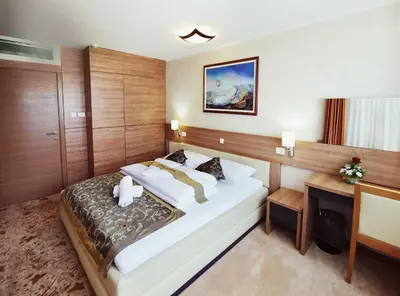 a hotel room with a bed and a desk at Hotel Kardial in Teslić