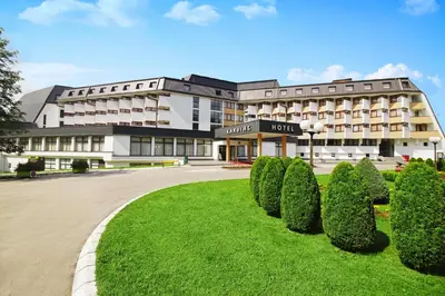 a hotel with bushes in front of a building at Hotel Kardial in Teslić