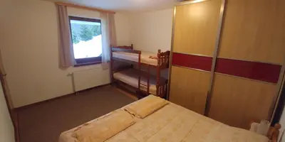 a small room with a bed and a window at Lux - Apartment Snow Oasis in Vlasic