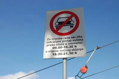 a sign for a no parking sign on a pole at Lux - Apartment Snow Oasis in Vlasic