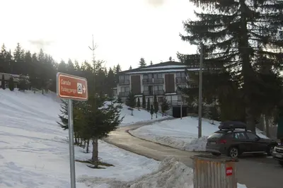 a car parked in front of a house in the snow at Lux - Apartment Snow Oasis in Vlasic