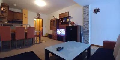 a living room with a table and a kitchen at Lux - Apartment Snow Oasis in Vlasic