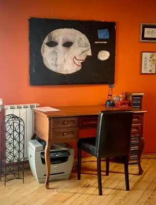 a desk with a skull painting on the wall at Kula hacienda in Tuzla