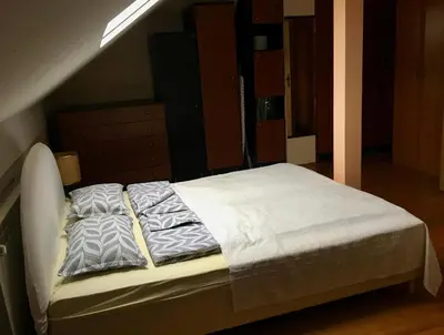 a bed with white sheets and pillows in a room at Kula hacienda in Tuzla