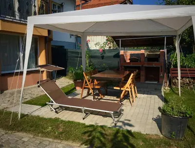 a table and chairs under a white canopy at Kula hacienda in Tuzla