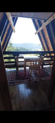 a wooden table sitting in a room with a view at Vikendica A Vlasic in Vlasic