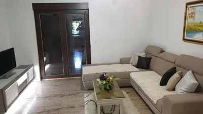 a living room with a couch and a tv at Villa Una Paradise in Bihać