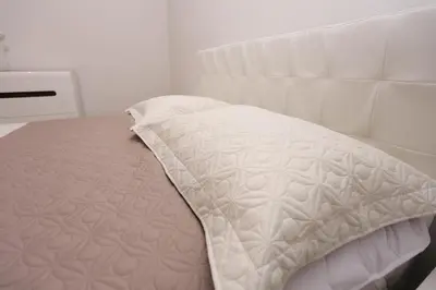 a close up of a white bed in a room at Villa Una Paradise in Bihać