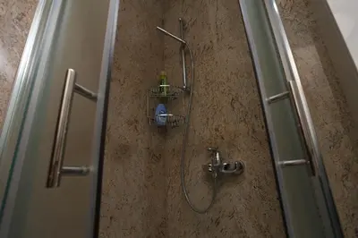 a shower in a bathroom with a glass door at Villa Una Paradise in Bihać