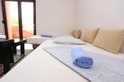 a blue towel sitting on a bed in a room at Villa Una Paradise in Bihać