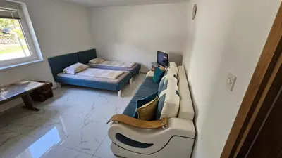 a living room with a couch and a bed at Apartman Nadija in Jajce