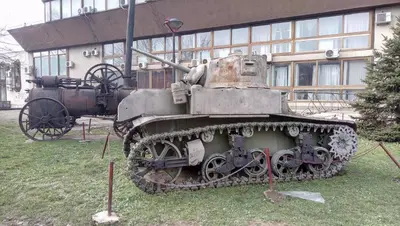 an old tank on display in front of a building at Stan na dan Banja Luka in Banja Luka