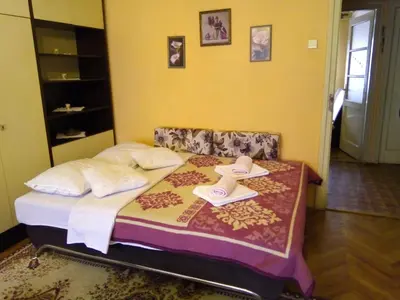 a bedroom with a bed with two hats on it at Stan na dan Banja Luka in Banja Luka