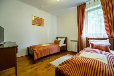 a hotel room with two beds and a television at Hotel Sunce Vlašić in Vlasic